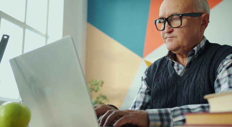 Senior man working on laptop computer